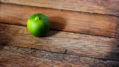 Green lime on wooden table. Stock Footage 104689191