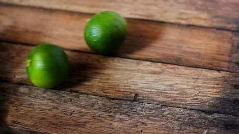 Green lime on wooden table. Stock Footage 104689201