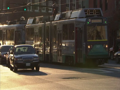 Green line train and passing traffic Stock Footage 86750311