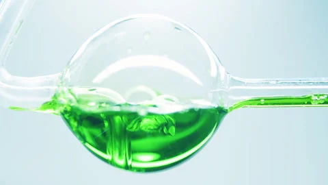 Green liquid boiling in glass flask. Stock Footage 242803667