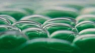 Green Liquid Bubbles Fall To The Bottom Stock Footage