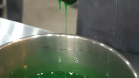 Green Liquid Dripping from Metal Spatula into Stainless Steel Bowl Stock Footage 345291982