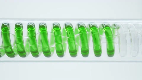 Green liquid flows in a spiral into the flask. Stock Footage 144010529