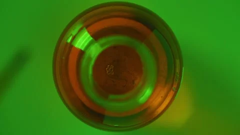 Green Liquid in Glass with Light Reflections Stock Footage 327199257