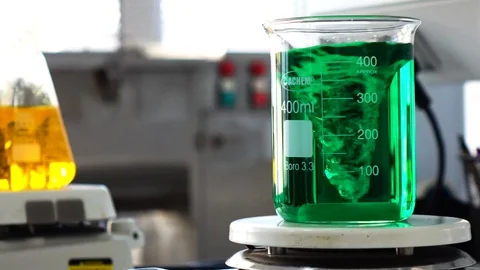 Green liquid inside a flask at a supplement laboratory Stock Footage 101229801