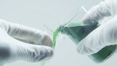 Green liquid in a laboratory flask and petri dish. Stock Footage 242804799