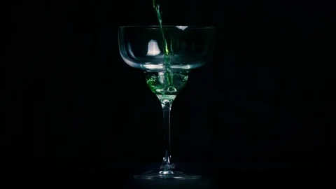 Green liquid Martini glass wild Stock Footage
