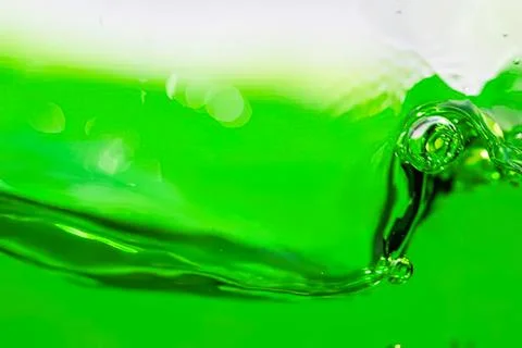Green liquid splash with bubble and wave in motion Stock Photos