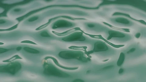Green Liquid Vibrate on Sounds Waves in Slow Motion Stock Footage 86422060