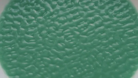 Green Liquid Vibrate on Sounds Waves in Slow Motion Stock Footage 86422213