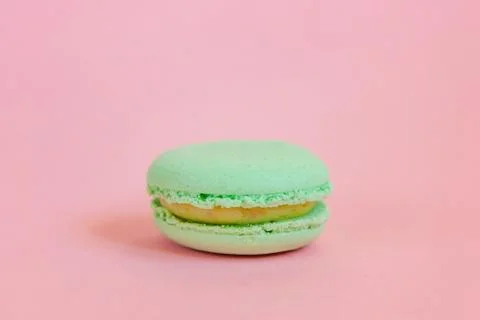 Green macaron on pink background Stock Photos