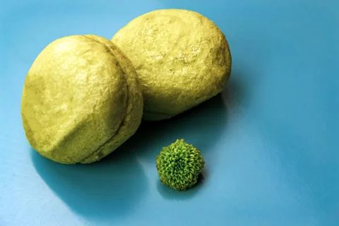 Green macaroons on a blue background Stock Photos