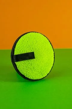Green Makeup Sponge on Orange Background for Product Display Stock Photos