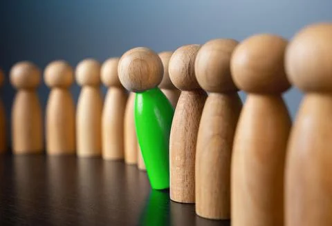 The green man looks out from the queue. Stand out from the gray mass. Initiat Stock Photos