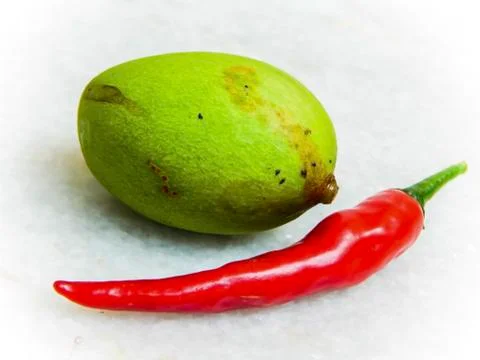Green mango and red chilli Stock Photos