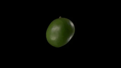 Green mango rotates on a black background. Stock Footage 125639613