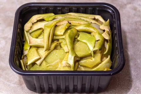 Green mango slices in a black plastic container for healthy snack Stock Photos