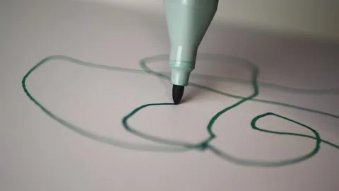 Green marker draws on a white sheet Stock Footage 221644789