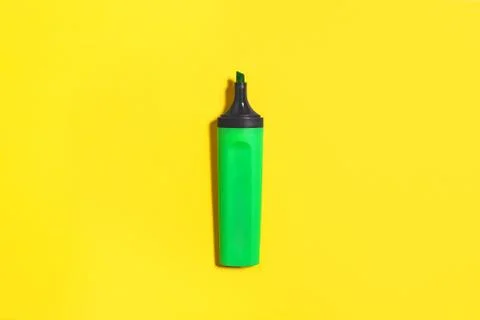 Green marker on a yellow background Stock Photos