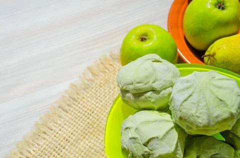 Green marshmallows on a plate. Stock Photos