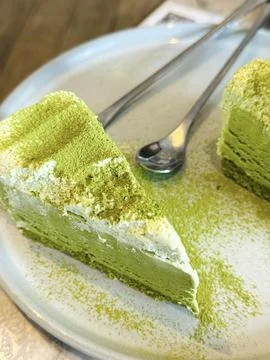 Green matcha cake with silver fork on the plate Stock Photos