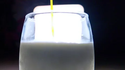 Green matcha in milk against studio light with black background 動画素材 342811020