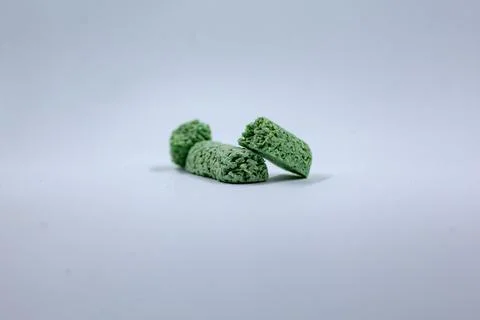 Green matcha protein bars broken into pieces on white background Stock Photos