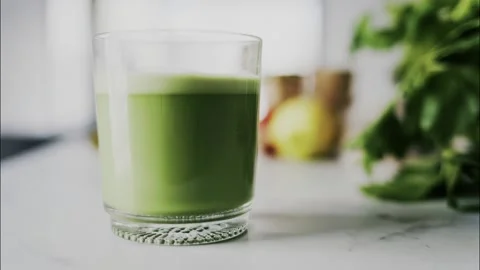 Green matcha tea served in clear glass cup on marble kitchen table with fre.. Stock Footage 339464228