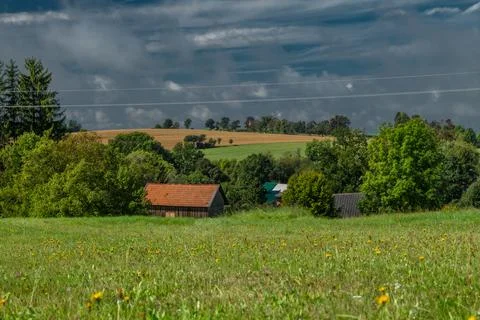 Green meadow and fields with rural buildings in Roprachtice CZ 08 31 2025 Stock Photos