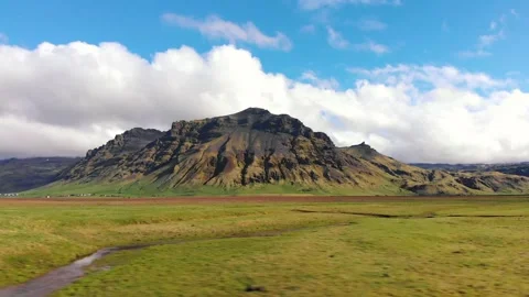 Green meadow and typical mountain in Iceland on a beautiful sunny day of spring Stock Footage 130853442