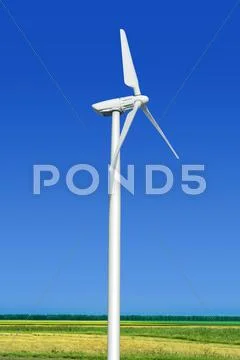 Green meadow with wind turbine Stock Photos
