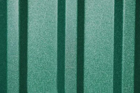 Green metal profiled sheets surface, under the sunlight. Stock Photos