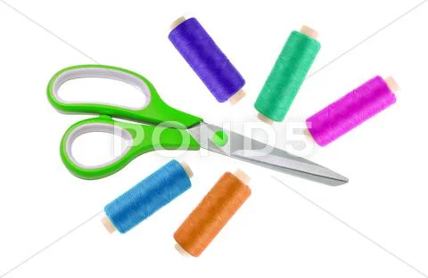 Green metal scissor and colorful sewing threads isolated on white Stock Photos