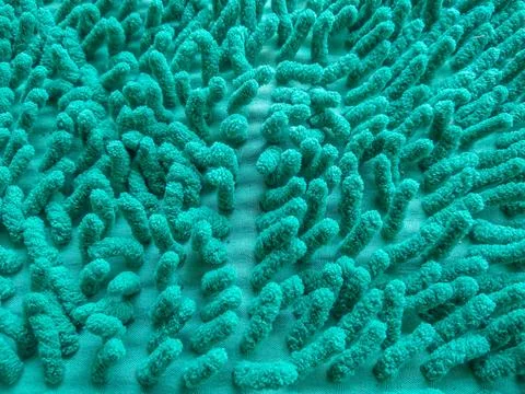 Green microfiber chenille doormat texture full-frame background Stock-Fotos