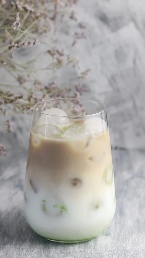 Green mint syrup is poured into cold coffee with milk. Stock Footage 160815112