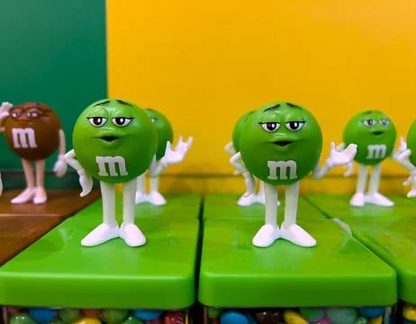 Green M&amp;M candy boxes at M&amp;M store in London Stock Photos