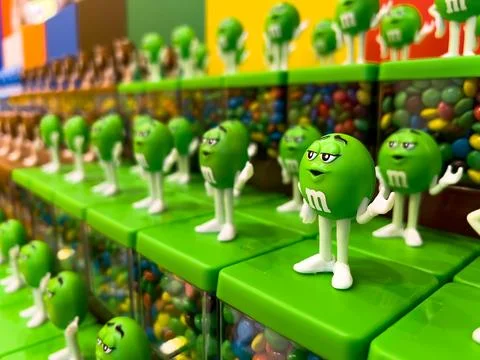 Green M&amp;M candy boxes at M&amp;M store in London Stock Photos