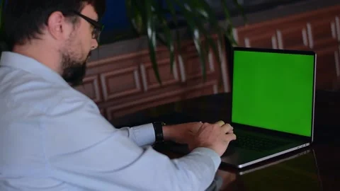 Green mock-up screen on the laptop man at sitting Stock Footage 155391735