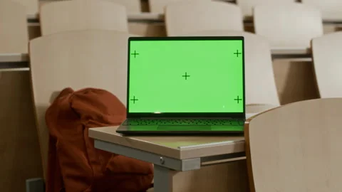Green Mockup Display of Laptop Placed on Desk in College Lecture Hall Stock Footage 306679318