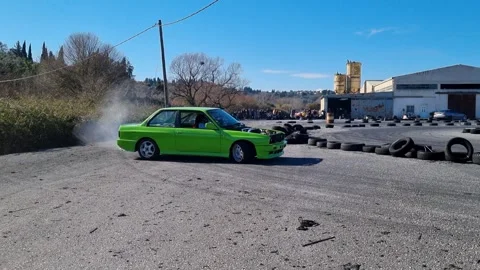 Green Modified Car Drifting on a Racetrack with Tire Smoke in Corfu Greece Stock Footage 326994036