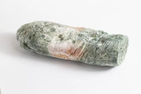 Green moldy bread on a white background, isolate. Loaf with mold, macro Stock Photos