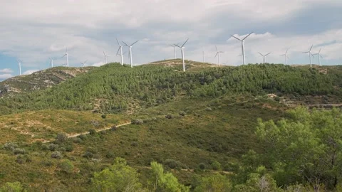 Green mount and Trees swaying by the Wind. Windmills on the background. South 스톡 동영상 146043650