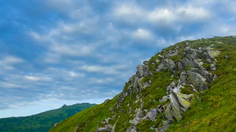 Green mount slope on dense cloudy sky background time lapse scene Stock Footage 301083284