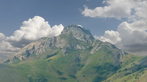 Green mount top and dense cumulus clouds around, Video stock 120255114