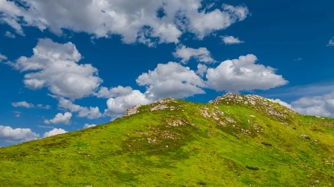 Green mount top on a cloudy sky background, time lapse scene Stock Footage 102221355