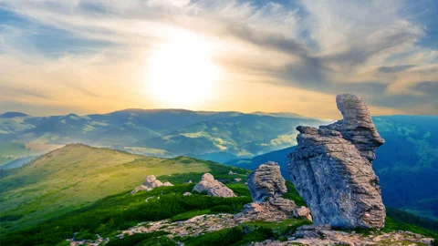 Green mount top with heap of huge stones at the sunset Stock-Footage 310090010