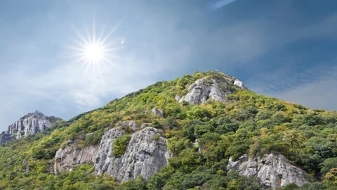 Green mount top in light of sparkle sun time lapse scene Stock Footage 178882921