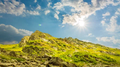 Green mount top in a rays of sun time lapse scene Video stock 297760209