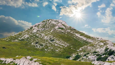 Green mount top under a sparkle sun Stock Footage 250154894