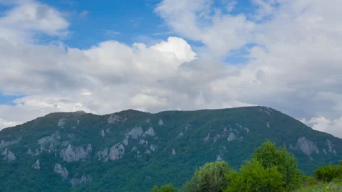 Green mountain chain in dense clouds Stock Footage 327316750